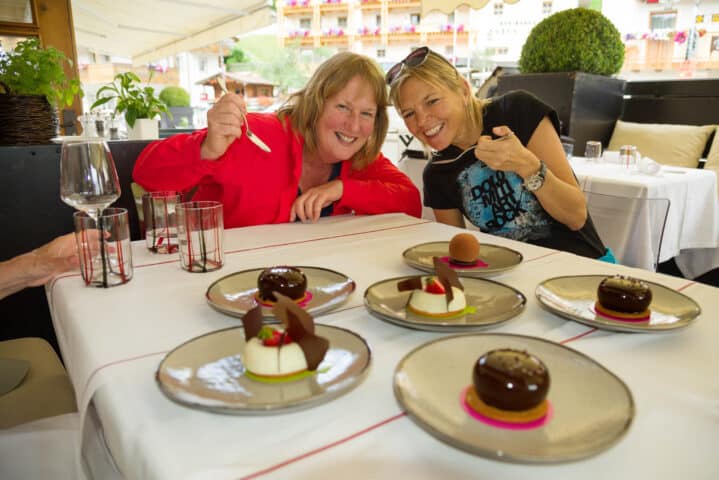 Two women enjoying dessert.