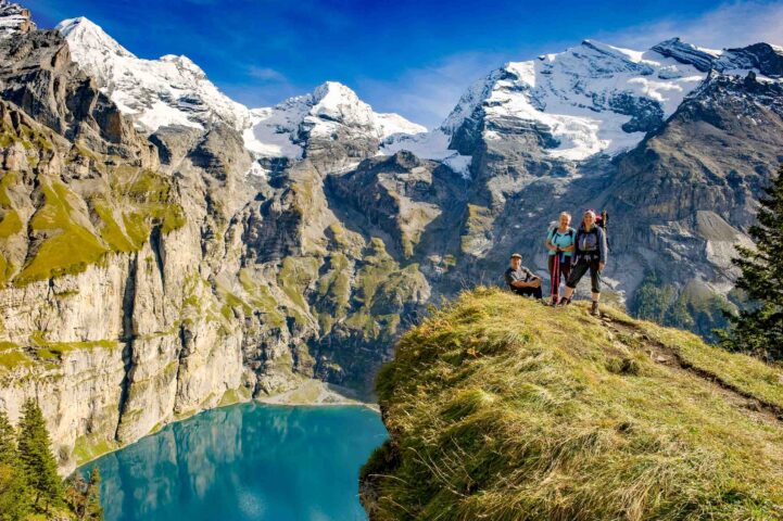 A group of hikers passing Lake Aeschinensee.