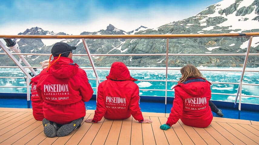 Three people on an expedition ship in Antartica.