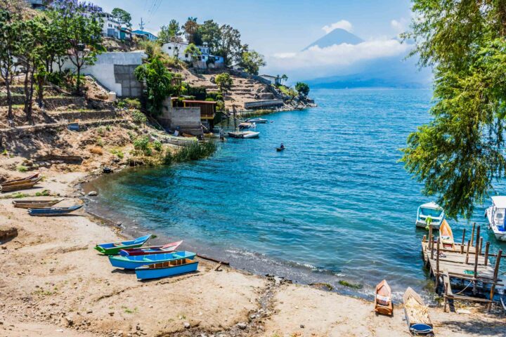 A beach with boats at shore.