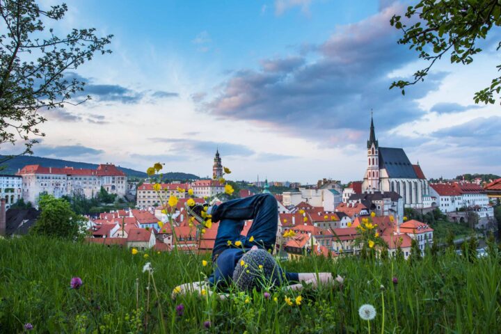 A tourist relaxing in a field in Cesky Krumlov, Czech Republic.