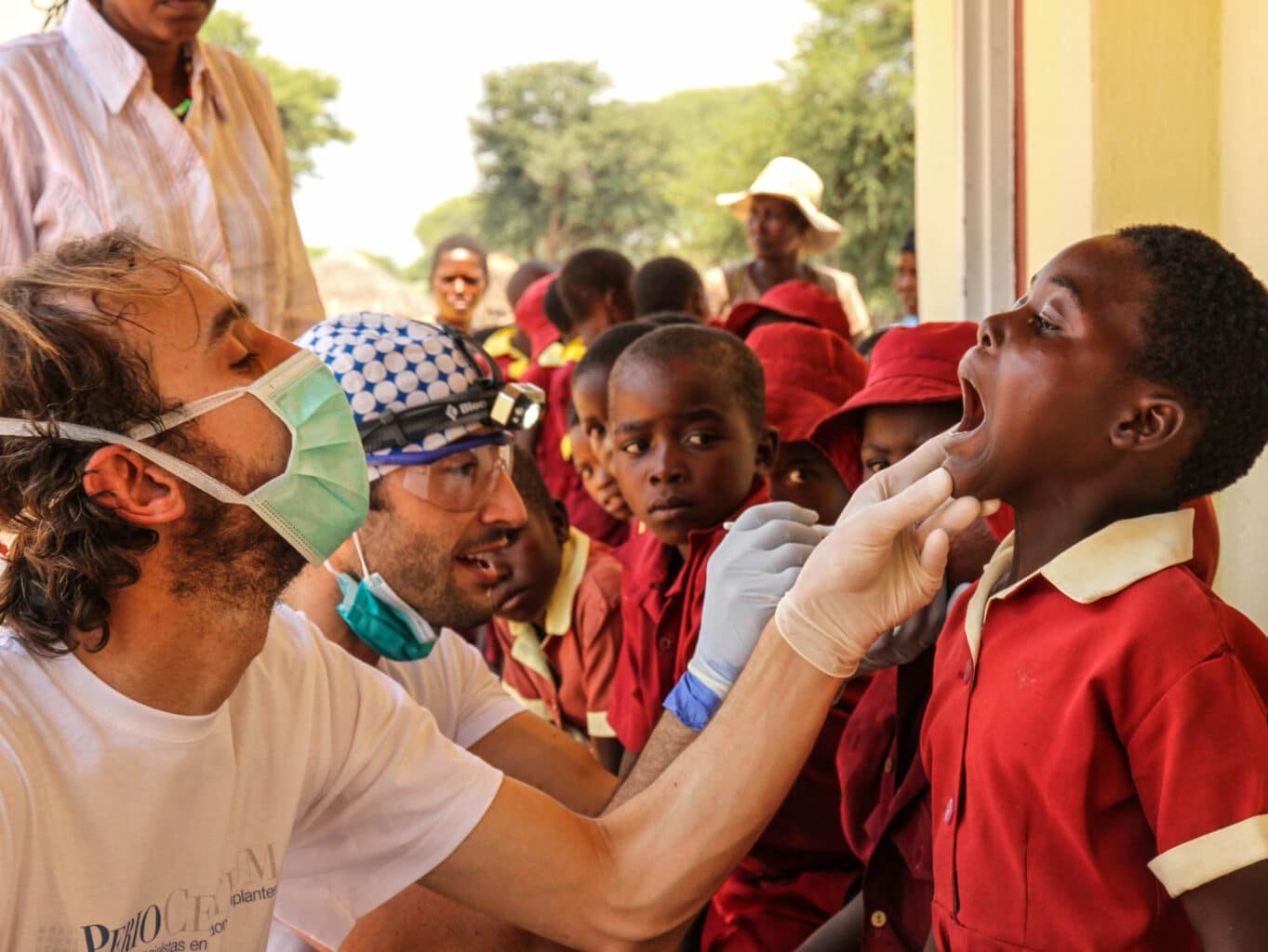 A dentist checking a child's teeth.