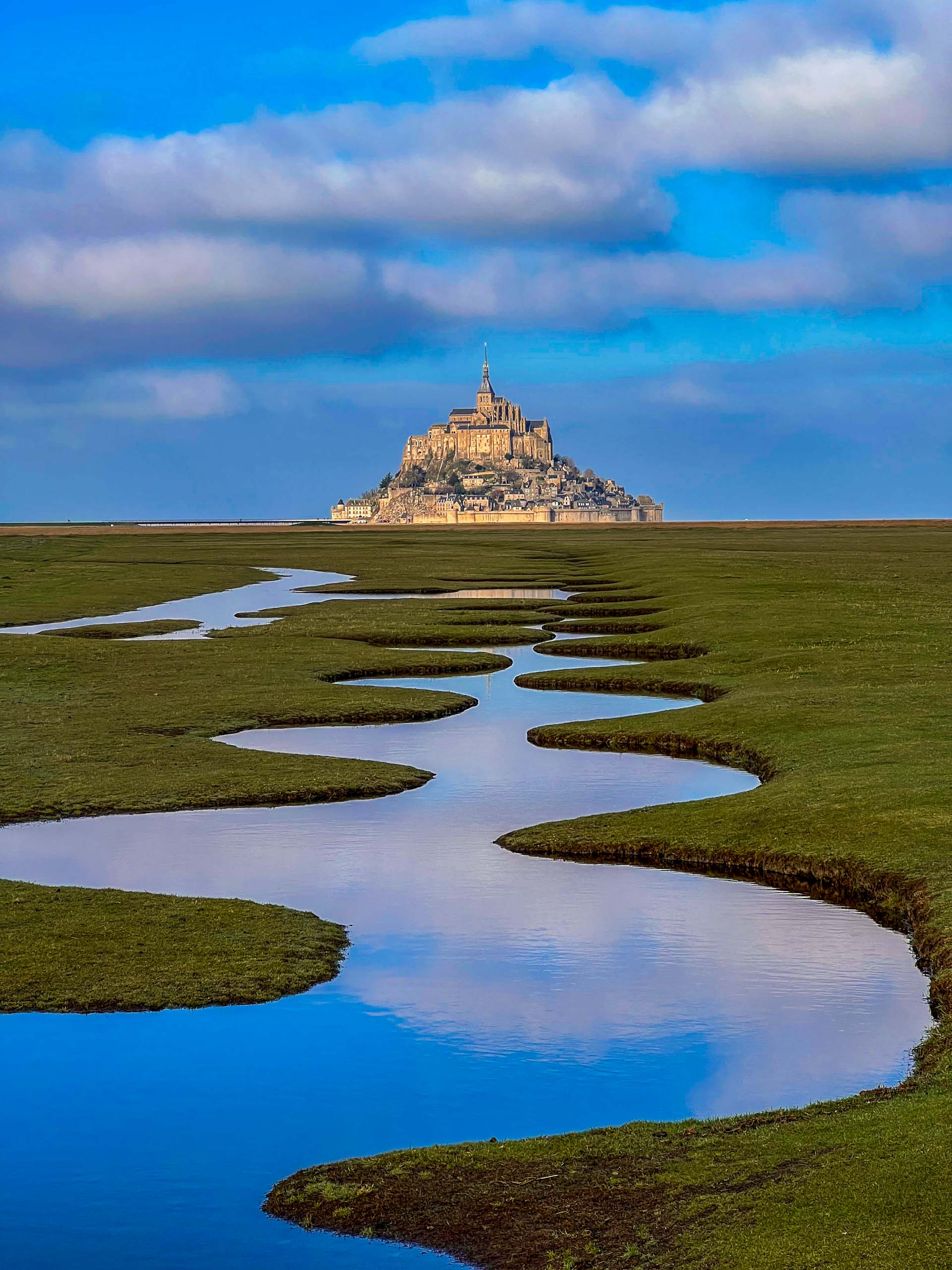 Salt marsh and Mont Saint-Michel landscape in Normandy, France.