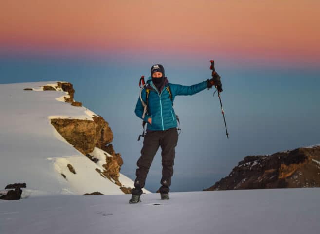 A hiker at Mt. Kilimanjaro during sunset.