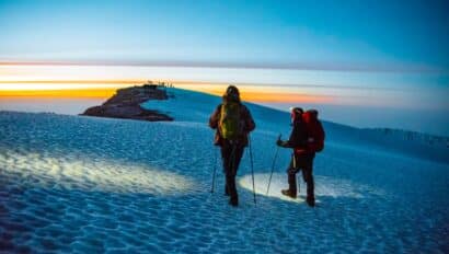 Two travelers hiking up a. summit in Kilimanjaro.