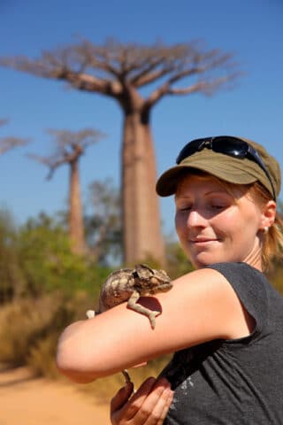 A chameleon on a tourist's arm.