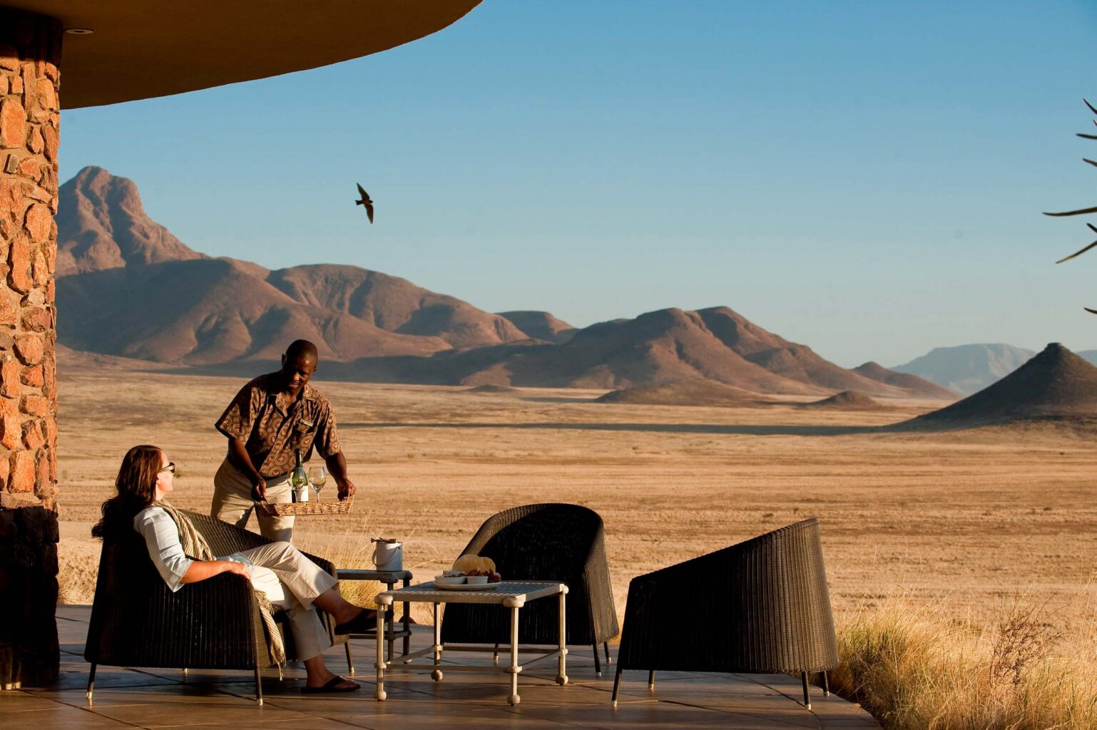 A traveler being served a glass of wine.