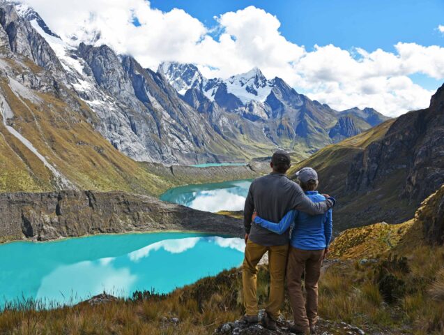 A couple enjoying a view of mountains in Peru.