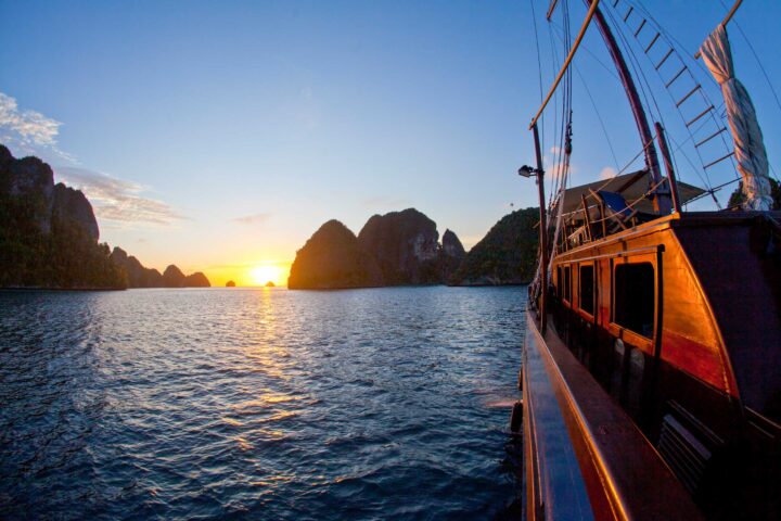 A boat in Raja Ampat at sunset.