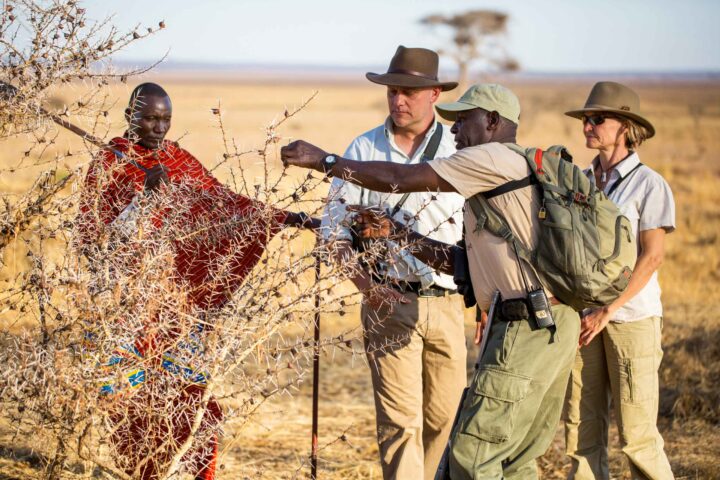 A safari guide and tourists in Tanzania.