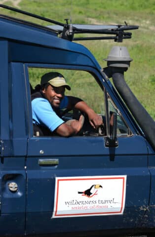 A Wilderness Travel guide in a safari vehicle.