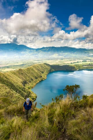 Laguna Cuicocha lake with hiker